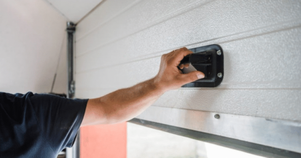 Person pulling garage door emergency handle.