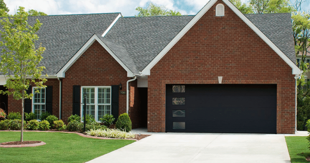 red brick house with black garage door